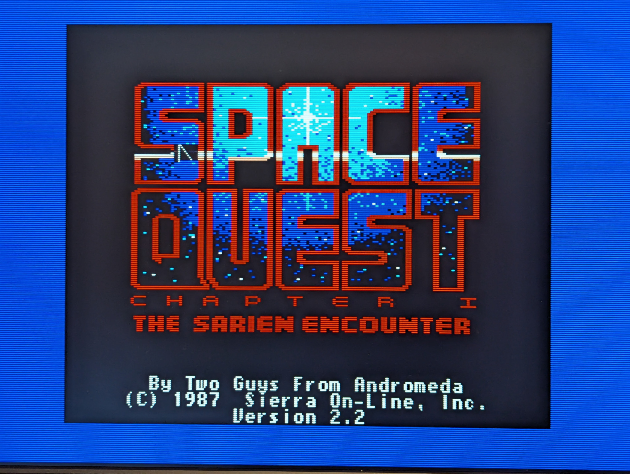 A photograph of the title screen from the game 'Space Quest: Chapter 1, the Sarien Encounter' for the Apple IIgs.  This version is (c) 1987, Version 2.2.