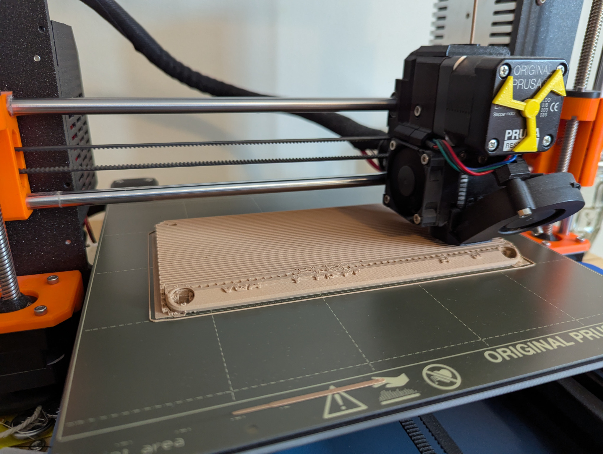A photograph of a new top plate for the GBS-C enclosure, being printed on a Prusa MK3S 3-D printer.